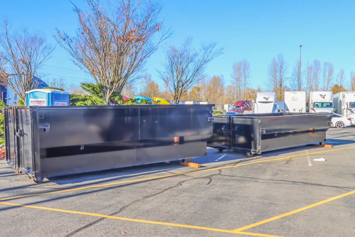 Professional dumpster rental service with roll-off container on residential driveway in Grosse Ile